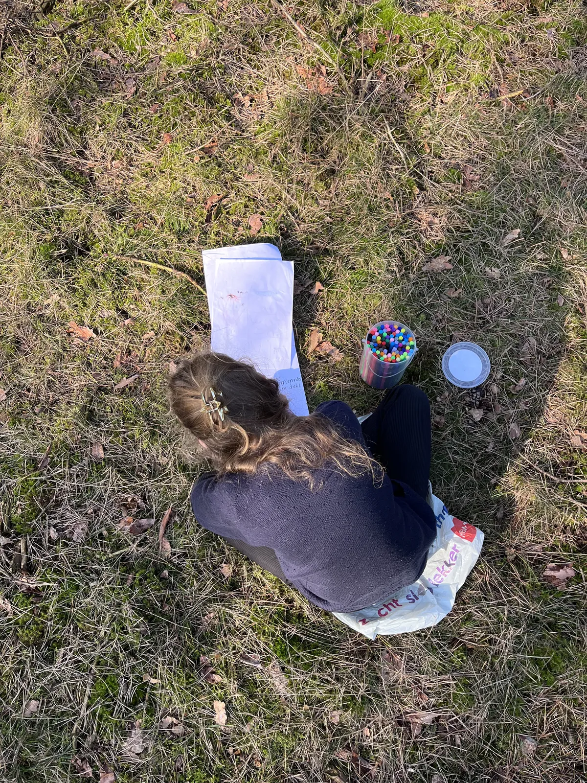Child plays and draws in nature